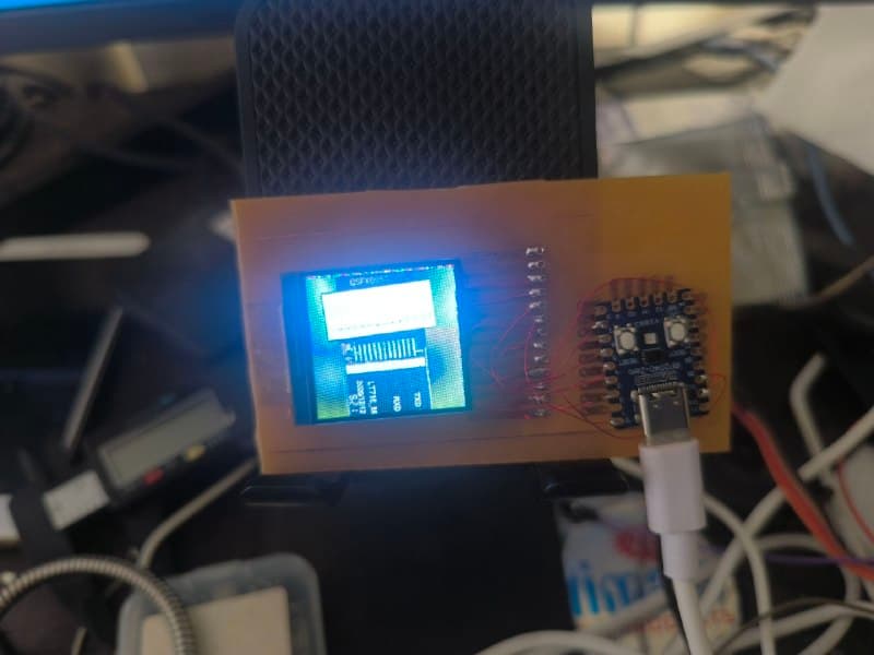 The etched board displaying a photograph of the watch motherboard and its pin table, recognisable but rendered in wrong blue and green tones